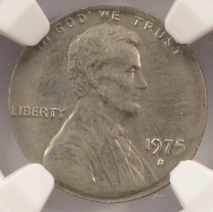 1975 penny struck on dime planchet appearing silver-colored and smaller, shown next to a normal copper 1975 penny for comparison